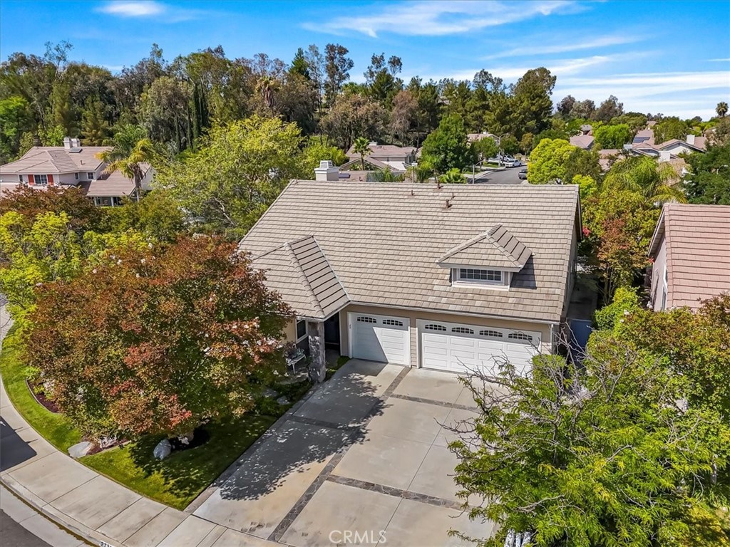 Welcome to this beautifully maintained single-story gem nestled in the heart of Valencia! Located in a charming and quiet Northbridge neighborhood with level streets, this home offers 3 generously sized primary suite and secondary bedrooms, 2 remodeled bathrooms, thoughtfully designed for comfort and functionality. Primary bath with soaking tub and glass/tile shower. Inside features soaring high ceilings and an open, airy layout filled with large windows providing boundless natural light. Plantation shutters add timeless elegance throughout, while the kitchen boasts granite countertops and rich dark wood cabinetry with self-closing drawers, built-ins and under cabinet lighting with hidden power outlets —perfect for convenient everyday living or entertaining special guests. Large laundry room with granite counter, cabinets and soaking sink. Pull down storage allows attic access for additional storage. Enjoy seamless indoor-outdoor living with a spacious, private pool-sized backyard featuring a built-in BBQ and two covered patio areas—ideal for dining al fresco or relaxing in the abundant shade. Off the Primary bedroom is a private patio wired for spa. The 3-car garage offers plenty of storage and convenience. Situated in a sought-after community with low HOA dues, you'll have access to sparkling pools, scenic parks, and beautifully maintained walking paths—all just moments from top-rated schools, shopping, dining, and commuter access. Come and see this well maintained one of a kind property.
This is single-story living at its best in one of Valencia Northbridge's most desirable neighborhoods.
