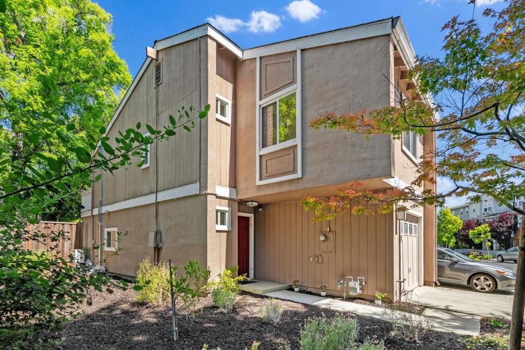 East Facing updated townhome offering comfort, function, and outdoor enjoyment. The main level features a spacious living room with a new gas fireplace, elegant tile surround, and sliding glass doors that open to a private backyard retreat. The newer remodeled kitchen showcases white shaker cabinets, granite countertops, recessed lighting, and stainless steel appliances. Enjoy new mini-split heating and cooling systems in all living spaces for year-round comfort. The backyard has been recently enhanced with custom pavers, a built-in bench, and a mature lemon tree, perfect for relaxing or entertaining. Downstairs half bath includes a newer shaker-style vanity with granite top, custom mirror, and lighting. Upstairs, the primary suite offers vaulted ceilings, a generous balcony, and a wall-to-wall closet. The en-suite bath features a newer vanity, granite top, and a stall shower with decorative tile and a custom glass enclosure. The second bedroom also has vaulted ceilings and a large walk-in closet. A second full bath includes a shower over tub with a newer glass door and matching vanity. Additional highlights include in-unit laundry with full-size washer/dryer and storage, new interior paint and flooring throughout, and a prime location near Google, parks, and top-rated schools.