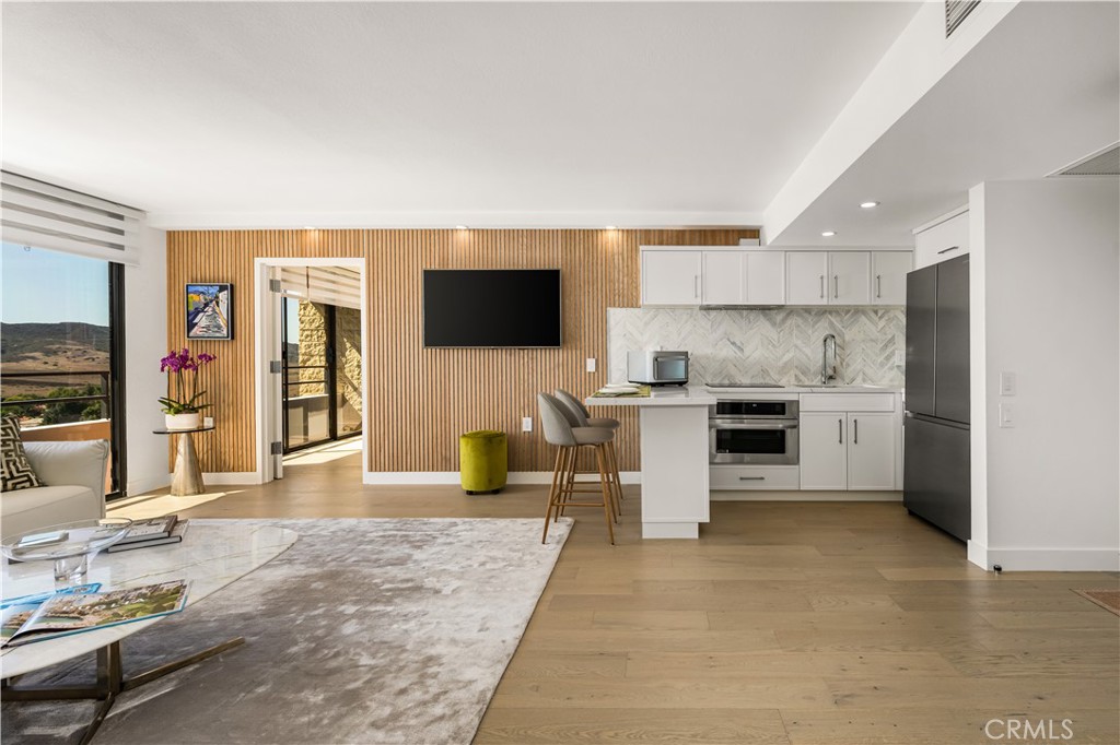 Introducing the Wyzr Smart Home designed by the co-founders of the Wyzr App connecting people inside and outside the home. Wyzr is an AgeTech Collaborative™ from AARP portfolio company. Welcome to an unparalleled luxury smart home residence in Orange County’s premier 55+ community. This 10th-floor end unit in Laguna Woods Towers with floor to ceiling windows has been curated for elevated living with custom built-ins and custom finishes in every room. Dual master suites offer the privacy of en-suite baths - the primary with a new soaking tub and the guest suite with an expanded walk-in shower. Custom vanities and LED smart mirrors bring a spa-like experience. The gourmet kitchen is a chef’s dream, showcasing custom cabinetry by a celebrity designer, french oak flooring, modern acoustic wood paneling, and state-of-the-art appliances including a Brava Smart Oven, LG Speed Oven, Samsung Smart Refrigerator, and Moen voice-activated faucet. Technology seamlessly integrates throughout the home with Alexa-enabled recessed lighting, smart climate control, entertainment systems, and an Echo Show 15 with Echo Dots that can be configured for emergency response. Furnished by Natuzzi Italia, Europe’s leading luxury furniture brand, the interiors strike a balance between sleek Italian sophistication and welcoming comfort. Available furnished or unfurnished, the Wyzr Smart Home is not just a residence — it’s a statement of modern luxury designed specifically for 55+. Dues include all major utilities, $500 per month at 2 on-site restaurants, housekeeping, transportation and activities. Covered parking and storage included. The community features 7 clubhouses, 2 golf courses, 5 pools, 3 fitness centers, tennis, pickle-ball, art studios, a performing arts theater, equestrian facilities, 250+ clubs, and guard-gated security.