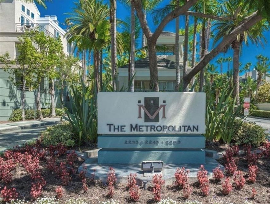 Resort-style living in the beautiful guard-gated community of The Metropolitan. This popular floor plan features 2 bedrooms, 2 baths, plus a den/office that can be used as a third bedroom. The home offers new paint and hardwood flooring throughout, 9-foot ceilings, and recessed lighting.

The kitchen includes granite countertops and backsplash, custom high-gloss white cabinets, a double-wide sink with chrome faucets, and all appliances including a washer and dryer. The den/office features custom built-ins with a two-person workstation. The primary suite includes a dual-sink granite vanity, tumbled marble backsplash, walk-in shower, and a soaking tub. The guest bath offers granite counters and a full-size walk-in shower with seamless glass.

Community amenities include a large pool, spa, clubhouse, and fitness center surrounded by lush tropical landscaping. HOA dues cover gas, water, sewer, and trash. Ample guest parking available. A must see!