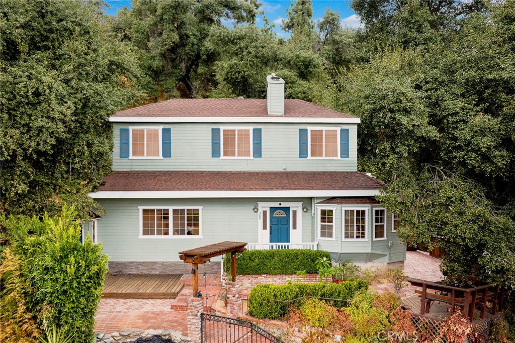Welcome to your perfect foothill retreat, sheltered by oak trees and where every room has a view overlooking the San Gabriel Valley. This split level ranch was expanded to a second level in 1990 and is now a 3 bedroom/3 bath hillside home that is nearly 2,000 square feet with hardwood floors throughout and fully air-conditioned.
The addition boasts a suite encompassing the entire upper floor with a sitting area and a primary bedroom with a gas fireplace, walk-in closet, and an adjoining full bathroom that has a jetted bathtub.
The spacious open living room has a rustic stone fireplace that is wood burning, perfect for cozy entertainment with family and friends. This warm homey feel extends into the expansive kitchen and dining area that has a high beamed ceiling with end to end skylights bringing in sunshine throughout the year. The kitchen has an abundance of storage including a walk-in pantry. Finally, there is a step-down den that can be transformed into a man cave dream or a game room for kids.
This mountain property sits only blocks away from Mary’s Market, the Mount Wilson Trail, nearby “Turtle” Park and the quaint charm of Sierra Madre with its unique shops, parks and restaurants.
This is your opportunity to experience the foothill lifestyle and enjoy the deer and buck wandering the neighborhood, take in the breathtaking sunrise and sunset views from the oak tree sheltered gazebo, and sit out on the deck looking over the flagstone pond and views of the Valley.