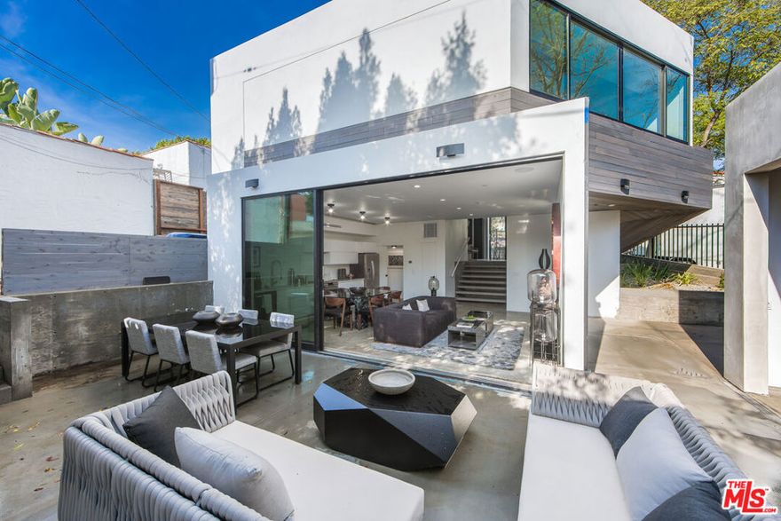 Experience refined West Hollywood living at 855 Hilldale, a striking 1-bedroom, 1.5-bath architectural residence located in the heart of the Norma Triangle. Designed with seamless indoor-outdoor flow, this award-winning home features dramatic floor-to-ceiling Fleetwood glass doors that open to a large private patio perfect for entertaining or quiet relaxation. Built in 2017 and honored with the AIA Home of the Year Award, the residence showcases impeccable design with concrete floors, marble bathrooms, and custom finishes throughout. The open-concept living and dining area connects effortlessly to the chef's kitchen, complete with high-end appliances and sleek, modern cabinetry. The primary suite offers a spa-like marble bath framed in black steel and a private patio for morning coffee or evening wind-downs. Additional features include in-unit laundry, a garage, smart home integration, premium fixtures, and high-end finishes. Available furnished or unfurnished with flexible short-term leasing options. Nestled on a quiet street just moments from Beverly Hills, Melrose Place, and the Sunset Strip, 855 Hilldale offers architectural integrity and modern luxury in one of Los Angeles' most sought-after enclaves.