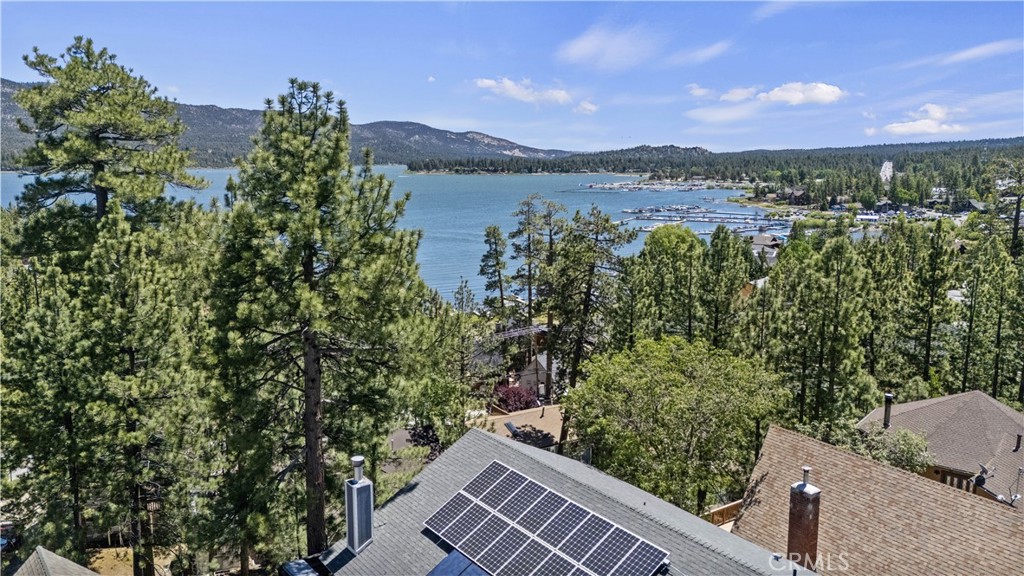Incredible LAKEVIEW from this huge custom residence located on a lovely small cul de sac. Awesome upgrades include owned solar system (owner has no electric bill!), oversized tankless water heater and full house water filter system, central A/C, quick full house vent system for instant cooling, and luxury fireplace insert. The primary suite is on the main level with a beautiful bathroom and spacious walk in closet. There is a large guest bedroom and second full guest bathroom on the main level. The star of the show is the immense great room with soaring cathedral ceilings, expansive center island kitchen w/ both gas range, second electric cooktop and oven, granite counters and LAKEVIEWS! This is the home to entertain your guests with fun lakeview bar in the greatroom, unbeatable views from the living, dining rooms and decks. Downstairs there is a fabulous game room with pool table, antique bar, dart board, tv area and half bath. Also, downstairs are two more generously sized guest bedrooms and another full bath. The upper and lower decks are "trek" decks and both have views of the lake. This is the house to watch the fireworks on 4th of July! 40258 Narrow Lane is clean as a whistle, has been immaculately maintained and will sell furnished per inventory list. It has not been a vacation rental but would sleep 12-14 easily.