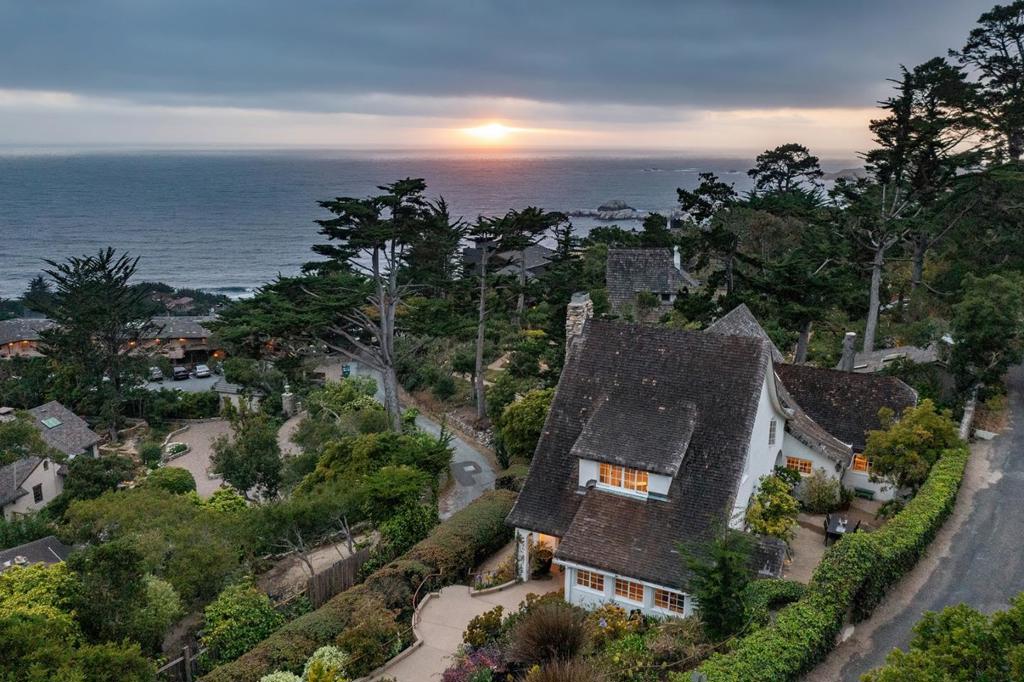 Offered for the first time in decades, this 1925 Tudor Revival gem is a once-in-a-generation opportunity to own a piece of Carmel Highlands history. Designed and built by M.J. Murphy this architectural treasure stands as one of the most authentic and enduring examples of his work. Set on a private knoll above Tickle Pink Inn, surrounded by English-style gardens the residence features hallmark Tudor details inlcuding pitched gables, hand-hewn beams, 2 masonry wood-burning fireplaces and custom retored casement windows true to a 1920's design. With four bedrooms, all with ensuite bathrooms, rich wood-clad walls, most windows facing the Pacific Ocean and multiple french-doors that open to the private, protected courtyard in the back of the home this home offers both emotional resonance and architectural distinction. This home also boasts an elevator, generator and full, mostly finished basement space with an office and workroom. While historically significant, it is not under formal preservation, allowing for flexibility and thoughtful updates. Located just 10 minutes from Carmel-by-the-Sea, this legacy home offers peaceful seclusion and coastal elegance.
