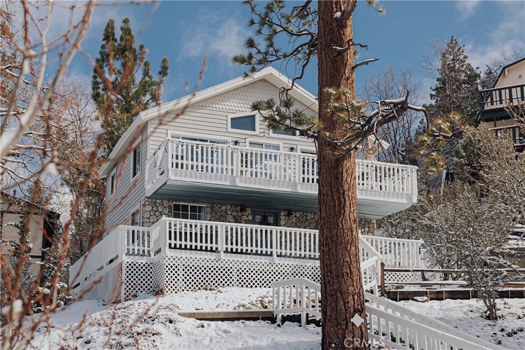 Expertly curated by seasoned entertainment and design industry professionals, this stunning 2-bedroom, 2-bath home in highly desirable Moonridge has been transformed into a high-performing short-term rental with 90+ five-star Airbnb reviews. Set on a generous lot with ample parking and breathtaking, unobstructed ski-slope views, the home features an open-concept upstairs living space with a wood-burning fireplace. A 80” projector screen, and upgraded kitchen with Jenn-Air appliances, sleek new refrigerator, and built-in water filtration are just a few of its attributes. Downstairs also offers a laundry/mudroom, and a boat-load of storage. This beautifully designed abode sleeps 8 comfortably.
Oversized windows fill the home with natural light and frame panoramic mountain vistas. The upper deck is ideal for entertaining, complete with gas BBQ, fire pit, and stylish lounge and dining areas. The lower deck features a private six-person hot tub with stunning views. Recent upgrades include central heating and A/C, water heater, Nest thermostat, and dryer.
Meticulously maintained and consistently booked—often by celebrity and repeat guests—this luxury retreat stands out in a highly competitive STR market. Seller open to negotiating sale of furnishings, supplies, marketing assets, and transition support, offering a rare turnkey investment in a high-barrier-to-entry location.