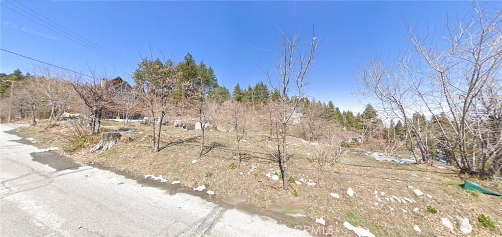 Don't miss this exceptional opportunity to own a spacious 0.55-acre corner lot just moments from the heart of town. Enjoy unobstructed mountain views and a location within walking distance to the Village’s charming shops and restaurants. Just a quick 5-minute drive to Snow Valley Ski Resort, snow tubing, and a variety of year-round family activities. Previously affected by the 2007 Slide Fire where a house once stood, this lot is now a blank canvas ready for redevelopment—perfect for building your dream mountain escape or full-time residence in a highly desirable, established neighborhood. Utilities are conveniently available nearby (buyer to verify availability and costs with local providers). Embrace the beauty of mountain living with endless possibilities!