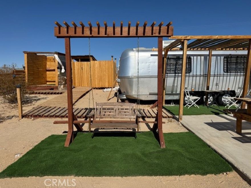 Beautiful piece of Property in Twentynine Palms. Running Water and Solar Panels on Property. 
Property had utility power in the past and Power pole is still on property (power not currently hooked up)  
5 Acres that include a 34' foot Avion (Airstream style) fifth wheel. RV includes Queen bed, 2 Twins, Kitchen, Dinette and full bathroom.
Property also has an outdoor toilet and outdoor shower connected to water supply. Cowboy Pool for those hot days. Fire Pit.
RV and outdoor toilet drain to cesspool on property
Water is turned on and provided by Twentynine Palms water district. 
Quiet oasis. Live on property full-time or use for weekend getaways. Close to downtown Joshua Tree and Twentynine Palms.
Enjoy Grubstake Festival, Night Sky Festival and Joshua Tree Music Festival.
Close to Joshua Tree National Park.