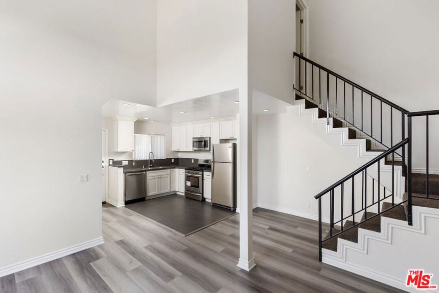 TOP FLOOR Remodeled loft style CORNER UNIT with an abundance of light and only one common wall. 30 feet high ceilings with lots of windows that greet you as you enter. Kitchen has stainless steel appliances & quartz countertops. The living room has a fireplace and patio. Large primary bedroom on the main floor with a huge walk-in closet, a second patio & vaulted ceilings. 2nd floor has another bedroom and bathroom. Central-AC and lots of extra closet space in the unit. Two side by side parking spots in a gated garage. This is a small 10 unit building in the heart of Valley Glen in Van Nuys. PET FRIENDLY