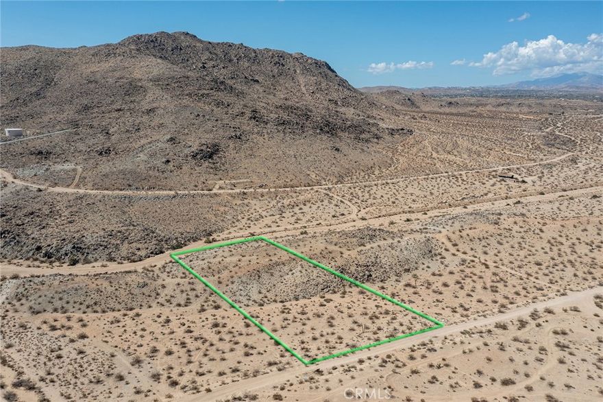 Have you ever dreamed of owning your own slice of Joshua Tree’s magic? This 2.31 acre parcel on Campanula Street places you just 10–15 minutes from the gates of Joshua Tree National Park, where the desert’s raw beauty becomes the backdrop for your vision. Endless skies, panoramic mountain views, and the iconic Joshua trees themselves surround the property, offering a rare opportunity to create something lasting in one of California’s most sought after and unique desert destinations. Whether you imagine a serene retreat, a striking modern build, or a lasting foundation for your future plans, this land delivers freedom and inspiration. Wake to golden desert sunrises, spend your evenings beneath starlit skies, and make this landscape your own.
