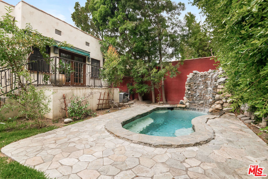 Magestic courtyard after main entrance. Come and discover this charming single-story 3-bedroom home. A large step-down living room includes a fireplace and French doors to the courtyard. Formal dining room opens to a chef's kitchen with breakfast nook, Viking appliances and custom mahogany cabinets. Master suite with French doors to the backyard has a bath with double sinks, designer tiles, and footed tub. Two additional bedrooms and 1.5 baths complete the interior. The home also features upgraded plumbing and , hardwood floors, security system and central air conditioning. Grounds include a guest house with 1bd/1ba, plunge pool, waterfall, built-in Viking BBQ, outdoor fireplace and limestone patio.