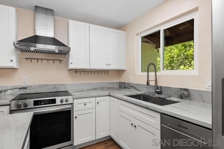 $50k price reduction! Light, bright and freshly remodeled townhome in the community of Shadow Tree. Step onto the private, upper level tree-shaded balcony before entering the spacious living room with a cozy fireplace. The kitchen is ready for entertaining with a large island, quartz counters and beautiful brand-new cabinets and stainless-steel appliances. Primary bedroom offers lots of storage with a walk-in closet. Full-size stackable washer and dryer included! One of the only units with TWO attached garages plus driveway parking. Enjoy the sparkling community pool and spa just steps away. Complex is VA approved! Seller is offering a credit for closing costs or an interest rate buy-down.