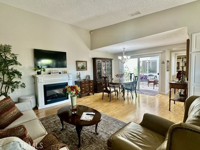 Rare atrium opportunity in highly Desirable Mutual 15! This home has it all,Convenient drive-up parking directly in front of the unit plus a dedicated carport. The Patio features a newly installed wrought iron gate, elegant pavers, and an electric patio cover, perfect for relaxing or entertaining year round. inside, you'll find double-pane windows,central heating and air, Hardwood floors, and high ceilings in the living room with electric fireplace. An open-air atrium sits in the center of the home, framed with windows and sliding glass door to enjoy the natural light from every angle. The kitchen was remodeled just a year ago with a new quartz countertop, touchless faucet, and recessed lighting. The spacious Bathroom offers an easily accessible large Shower with a built-in Seat,a new quartz vanity top, and a convenient full-size stacked washer and dryer in unit.