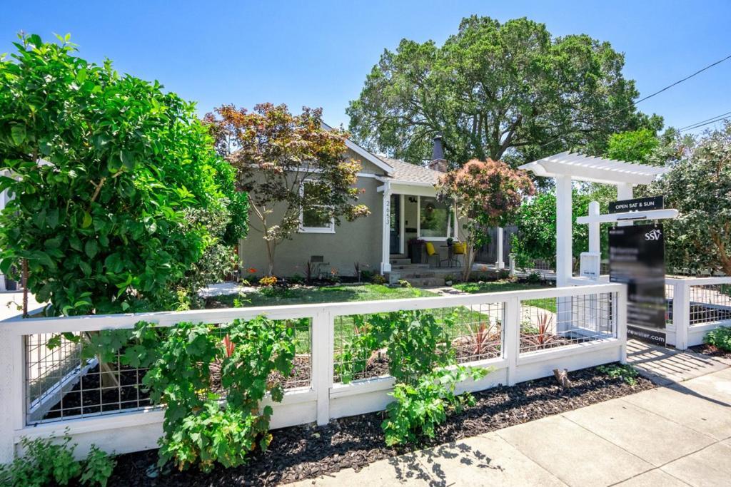Delightful Redwood City Retreat with Garden Oasis & Designer Touches Nestled in the highly desirable Mount Carmel neighborhood in Redwood City, this enchanting home offers the perfect blend of comfort, character, and convenience. A welcoming open-concept living and dining area centers around a stunning marble framed wood burning fireplace, setting the tone for cozy gatherings and everyday relaxation. The updated kitchen boasts granite countertops, a spacious stainless steel sink, and KitchenAid appliancesincluding a 5 burner gas rangeideal for the home chef. A bright and airy home office opens directly onto the sun-drenched backyard, offering a seamless flow for work or leisure. Additional highlights include hardwood floors, double pane windows and smart home upgrades such as a Nest thermostat, and integrated safety monitoring systems. Surrounded by lush landscaping and mature fruit trees, the private backyard is ideal for entertaining, featuring a detached garage tucked securely behind a gated drive. Located just minutes from vibrant dining and shopping in downtown Redwood City and Red Morton Park, this turnkey gem is a rare opportunity to enjoy peaceful living with urban convenience.