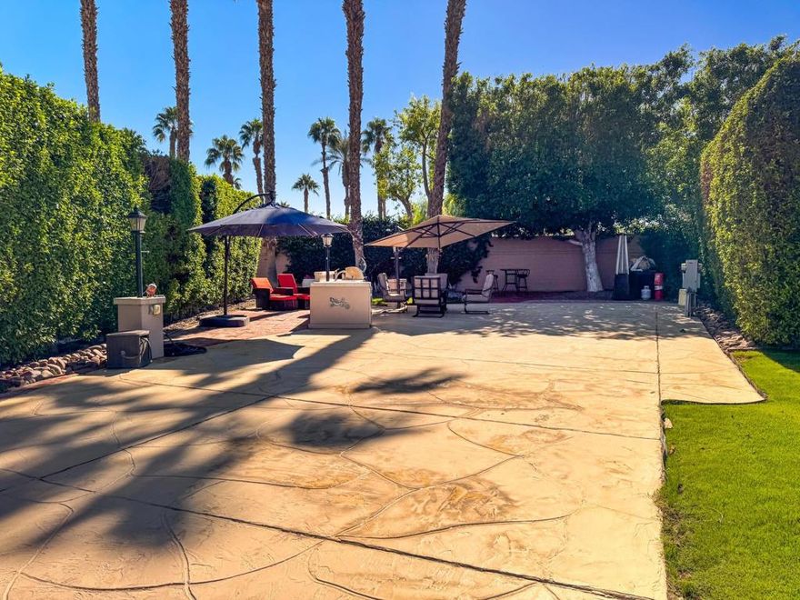 Outdoor Resort Indio is a Class A only RV Resort.This pie-shaped RV lot at Outdoor Resort Indio offers rare privacy and charm -- smaller in front, opening to a landscaped back lot with grass and a large shade tree. Your coach windshield faces north, keeping your coach cooler.Enjoy outdoor living with a tile-counter kitchen featuring a sink, built-in BBQ, hot water, and fridge. A fire table with four chairs, surfaced concrete with paver extensions, and ample parking complete the setup.Perfect for pet owners, the lot includes a large grass pet area and is just a short walk to the satellite pool, hot tub, laundry, and sauna -- everything you need for relaxed, resort-style living.