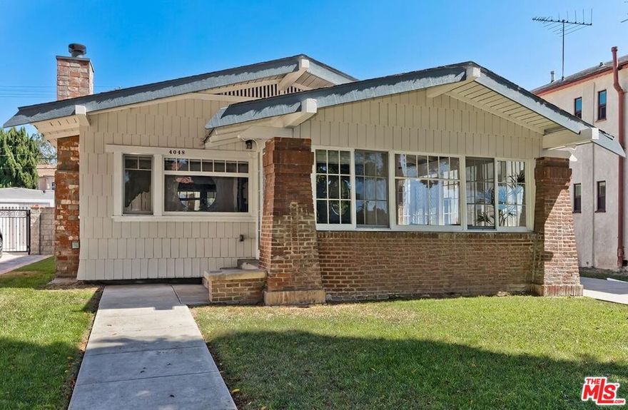 Charming 1913 Craftsman with Guest House in the Heart of Culver City. Step into a lovingly restored 1913 Craftsman perfectly positioned on one of downtown Culver City's most coveted, palm-lined streets near Carlson Park. Just moments from award-winning restaurants, trendy coffee shops, theaters, and vibrant nightlife, this rare property blends historic charm with modern updates. The main home features 2 bedrooms plus a den/office and a spacious sunroom filled with natural light. An original vintage front door welcomes you into the bright living room with gleaming hardwood floors, a classic brick fireplace, wood-framed windows, and elegant crown molding. The formal dining room boasts rich stained-wood wainscoting and double-hung windows, while the remodeled kitchen offers crisp white shaker cabinetry, quartz countertops, a convenient laundry nook, and an adjacent office/den. The updated bathroom showcases a tiled tub/shower and a stylish new vanity. Behind the main home, a private 1-bedroom, 1-bath guest house provides its own sunny living room with hardwood floors, wood windows, a galley kitchen with washer/dryer, and endless possibilities for extended family, guests, or rental income. A grassy backyard, detached carport, and large lot offer plenty of space to relax or expand. With desirable R4 zoning allowing up to four units, the property also presents an exceptional development opportunity build a duplex or even a townhome project on one of downtown Culver City's few A+ streets.