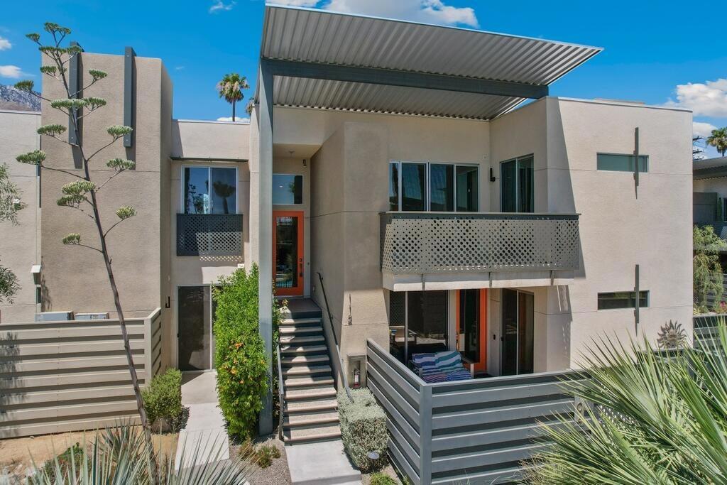Welcome home to the highly desirable 64 @ The Riv community. Built in 2019 this 2 bed, 2.5 bath home features a 3Kw owned solar panel system, and the interior offers an open and spacious floor plan with lots of natural light. The living room offers a gorgeous suspended cylindrical fireplace and a slider to the balcony with additional storage closet. The gourmet kitchen has a large island with breakfast bar seating, quartz counters, stainless steel appliances including a wine fridge, microwave, and luxury brand Fisher & Paykel refrigerator, gas range, and dishwasher! The 2 bedrooms each have private ensuites and are separated by the bathrooms and laundry closet, and each bedroom also offers walk-in closets, and mounted TVs. The larger bedroom also has sliding glass door access to the living room balcony. There is also a half bathroom for guests. Residents of this desirable community get to access a Resort-like pool and spa with beautiful landscaping! You can also enjoy views of the pool from your balcony! There is also a car-port, plenty of guest parking spaces available, and 4 EV chargers that are free of use to owners and guests! Conveniently located within a few miles of the Downtown Palm Springs area with many shopping and dining options, also near golf courses, casinos, and all that Palm Springs has to offer! Schedule your private tour today