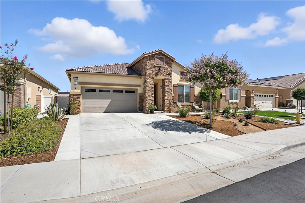 Welcome to resort-style living in the heart of Menifee's desirable 55+ community. This beautifully designed, energy-efficient (paid solar) home offers comfort, style and convenience at every turn. Step inside to soaring high ceilings and a bright open layout that features 2 bedrooms, plus a den/office and 2 bathrooms. The primary bedroom features an en suite bath with dual sinks, a pebble rock shower, a vanity and a generous walk in closet. The spacious open concept kitchen is a chef's delight featuring sleek quartz counter tops, upgraded cabinetry, stainless steel GE Profile appliances with wine fridge included, a 5 burner range and stylish luxury plank flooring that flows throughout the main living areas. Another added bonus is a Quiet Cool whole house fan. Enjoy year round relaxation with resort amenities including a sparkling pool, spa, pickleball, tennis courts and a fully equipped gym. Enjoy a tranquil backyard surrounded by beautiful low maintenance landscaping, blooming flowers, plants, private spa and endless butterflies that offer year round charm without the upkeep. This home also features a tankless water heater and an epoxy coated garage floor and built in storage racks. This turnkey home, with low monthly HOA fees is a great opportunity to make this beautiful home yours!