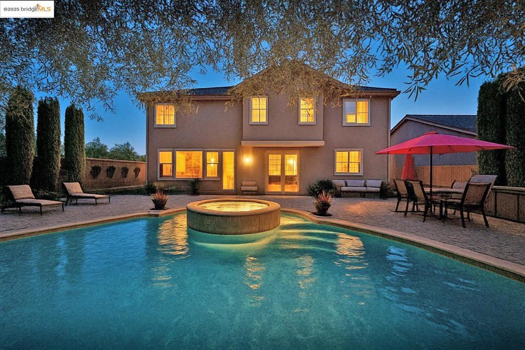 Discover Your Dream Home in a Exclusive Gated Community! Located at 6900 New Melones Cir, this stunning property is one of the best lots in Discovery Bay. Nestled within a secure, gated community, residents enjoy peace of mind and privacy. This spacious home features a luxurious backyard with views of the Delta from your front door, with 5 bedrooms and 4 baths, every inch of this fully updated palace is designed for comfort and style, including a suite downstairs for mother-in-law or 2 home office. Enjoy incredible amenities, including home gym, a home theater for cozy movie nights, and access to community facilities like parks, walking trails... Easy access to delta for your boating needs. A true one-of-a-kind gem! Must-see! Over $350.000.00 of upgrades, owned solar system