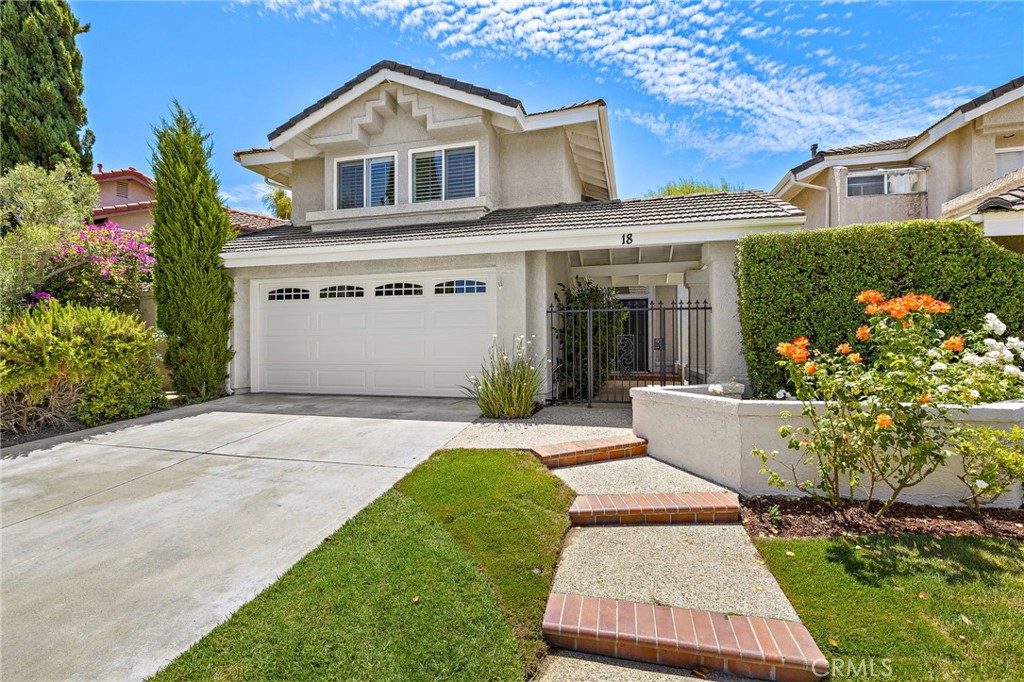 Leave no boxes unchecked—or unpacked—at this stylishly reimagined home in the Mariners Bluff community of Laguna Niguel’s sought-after Laguna Heights. Tucked on a quiet street and just a short stroll from George White Elementary School, this turnkey residence offers the space, upgrades, and location today’s buyers crave—paired with a calm, coastal ease that feels instantly like home. With approximately 1,832 square feet, three bedrooms, and two-and-one-half baths, the home offers room to grow and space to breathe. Set on nearly 4,000 square feet of thoughtfully landscaped grounds, the private backyard invites outdoor entertaining beneath open skies, while a gated front courtyard adds charm and function to the handsome traditional architecture. Inside, soaring vaulted ceilings, clerestory windows, and crisp white walls create an airy, sunlit welcome across the formal living and dining rooms. A custom fireplace anchors the living area, while elegant transitions lead to the heart of the home—a beautifully upgraded kitchen and inviting family room, each offering effortless access to the backyard. The kitchen blends classic and current with granite countertops, tray ceiling, peninsula seating, white cabinetry, and new LG stainless steel appliances, including a ThinQ French-door refrigerator. A breakfast nook with illuminated display cabinets provides the perfect setting for casual mornings and cozy conversations. A powder room with pedestal sink, a separate laundry room with cabinetry, and an attached two-car garage with built-ins enhance convenience on the main level. Upstairs, a skylit, multi-tiered staircase leads to two serene secondary bedrooms with mirrored closets, and a beautifully remodeled hall bath with dual sinks and a custom marble countertop. The vaulted-ceiling primary suite is a calming retreat with a charming window seat, walk-in closet, and a light-filled ensuite with soaking tub, separate shower, dual sinks, and skylight. Additional features elevate comfort and sustainability: solar panels, energy-efficient windows and sliders, recessed lighting, upgraded fixtures, and wood flooring throughout the main level. Moments from the golden beaches of Dana Point and Laguna Beach, world-class parks, scenic trails, and top-rated public and private schools, Mariners Bluff offers coastal living with an everyday lifestyle in mind.