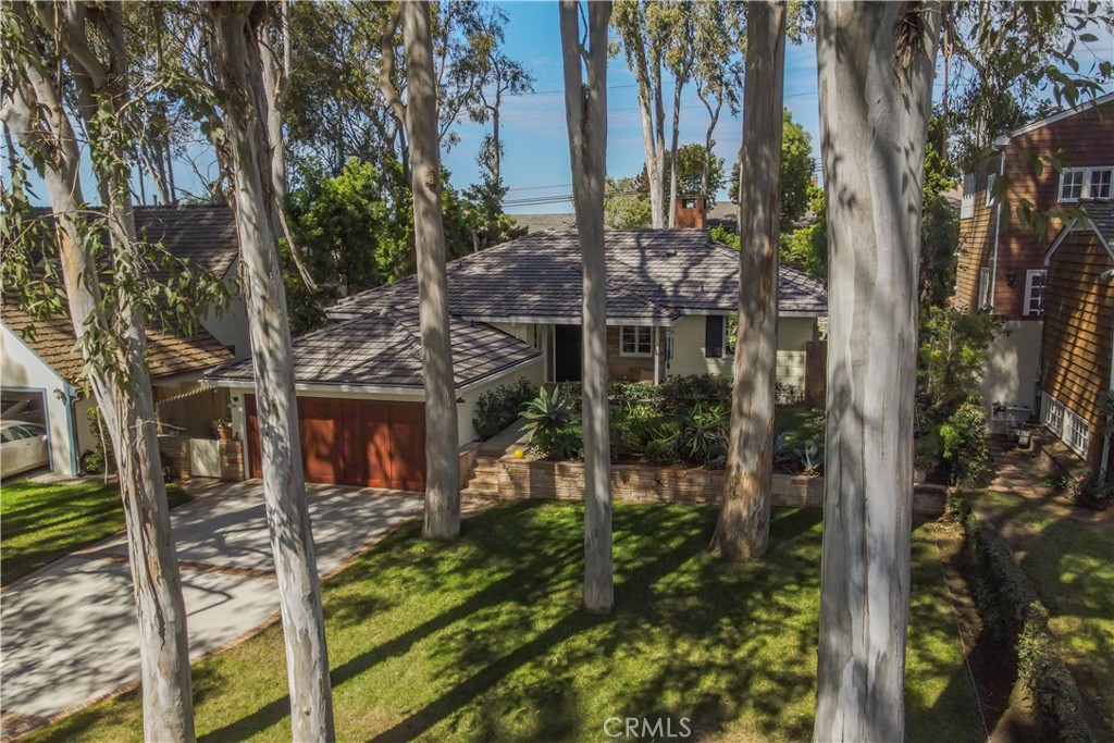 Idyllic Valmonte Grove Retreat.
Tucked away on one of the most sought-after streets in the coveted Valmonte Grove neighborhood, this single-level sanctuary blends mid-century charm with modern comfort—all set directly along the serene boundary trail. Nestled behind a lush grove of eucalyptus trees on a generous 7,500 sq. ft. lot, this home feels worlds away while remaining close to everything.
Step inside to a sun-drenched, sunken living room, where hardwood floors, soaring vaulted ceilings, and a wood burning stone fireplace create a warm, inviting centerpiece. Floor-to-ceiling windows frame views of the private, fully fenced backyard and garden, making the space perfect for both quiet mornings and lively entertaining.
The open-concept dining room and spacious kitchen flow naturally off the living room, offering hillside and golf course views. The chef’s kitchen, fully remodeled in 2017, boasts a 6-burner Viking range, high-end appliances, custom maple cabinetry, and abundant storage. A step-down den (ideal for a music room, playroom, or cozy lounge) opens through four large French doors into the tranquil backyard.
The home’s three bedrooms extend along the west hall, culminating in a peaceful primary suite complete with a Dutch door opening onto the garden. The modernist bathroom, beautifully renovated in 2019, features a marble walk-in shower, glass countertop vanity, stained glass window, and an abundance of natural light.
Additional features include:
Attached 2-car garage with laundry
Extended driveway for up to 3 additional cars
New roof, on-demand hot water heater, whole-house water filter, and built-in dehumidifier
Enjoy hillside and golf course views from the elevated front porch, or relax in the private backyard oasis—perfect for families, pets, and summer gatherings.
This is more than a home; it’s a lifestyle. Valmonte Grove offers peaceful, tree-lined seclusion while being just minutes from Riviera Village and a quick 4-minute bike ride to the beach.