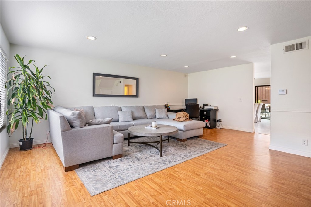 This is the opportunity you've been waiting for! Tucked away in the back row of the highly desirable Gardens community, this sharp 3 bedroom, 2.5 bathroom unit is updated and move-in ready! Main-level features a living and dining room with an updated kitchen that leads to an enclosed private patio with outdoor string lighting that is perfect for entertaining. Staircase with large enclosed storage area and laminate floors throughout, with tiled kitchen and dining room. The second level features all 3 bedrooms including a master ensuite with a spacious walk-in closet. Front door and all windows were recently replaced with new dual paned windows. Back alley includes plenty of parking which is convenient for visitors or guests. Short walk through the beautiful greenbelt to the nearby pool and tennis courts make this a prime location away from traffic. With nearby shopping, restaurants, and schools, this gem is ready for the next owner!
