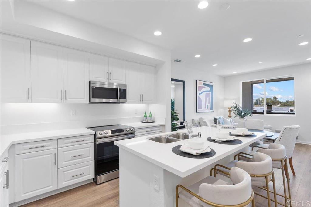New Construction Homes with PAID SOLAR, NO MELLO ROOS, and LOW HOA — where modern living meets everyday convenience! This brand-new 3-bedroom, 3-bathroom condo offers a perfect blend of comfort, style, and smart design. Step into an open-concept living space with 9-foot ceilings, recessed LED lighting, and luxury vinyl plank flooring, flowing seamlessly from the living room to a sleek kitchen equipped with granite countertops, a large island, stainless steel appliances, and a USB charging station for your tech needs. Enjoy peace of mind with Energy Star® certification, solar energy system, smart thermostat, and MERV 13 air filtration — ideal for eco-conscious homeowners. Each bedroom is generously sized, including a bright primary suite with an ensuite bathroom and modern finishes like engineered stone countertops, dual sinks, and chrome-framed glass shower enclosures. The attached 2-car garage adds practicality, while 22 guest parking spaces make entertaining easy. Plus, enjoy the benefits of no Mello Roos and low HOA fees. Perfectly located just minutes from Sharp Grossmont Hospital, SDSU, USD, and Cuyamaca College, and only a 10-minute drive to downtown San Diego or the Mexican border, this home makes commuting a breeze with easy access to I-8, Hwy 67, and I-125. Whether you're a first-time buyer, downsizing, or investing, this turnkey home checks all the boxes. Come see why Gateway is the perfect place to call home!
