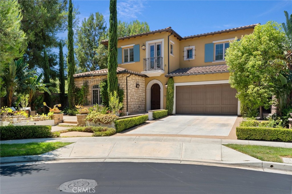 Experience luxurious living and grand-scale entertaining in this stunning Taylor Morrison Residence Four, located in the prestigious 24-hour guard-gated Groves at Orchard Hills. Set on a premium oversized corner lot at the end of a cul-de-sac, this home boasts a rare, large front patio with cascading fountain—an exceptional retreat for refined outdoor living. With over five bedrooms, six full baths, flex spaces, and extensive builder upgrades, this home is designed for versatility and elegance. The layout flows effortlessly from the arched foyer into a spacious dining room and dual gourmet kitchens—ideal for entertaining. The main kitchen showcases a generous center island with bar seating, Wolf appliances, a 6-burner + griddle station rangetop, dishwasher, and abundant high-end cabinetry. A fully equipped back kitchen complements with its own 2-burner and Wok burner + charbroiler station rangetop, refrigerator, dishwasher, and additional storage. Enjoy seamless indoor-outdoor living as the well-appointed dining room leads to the large living room with fireplace, which opens to a covered California room and a resort-inspired backyard featuring serene waterwall features, retractable awning, and a BBQ island—perfect for serene Southern California evenings. The main floor offers a rare second luxurious primary ensuite with duvet—perfect for extended family or multi-generation living, an additional bedroom, guest full bath, plus an oversized laundry and craft room adds convenience and function. Upstairs, a spacious flex room with a full bath offers flexibility for a 6th bedroom ensuite or family space. The upstairs primary ensuite features a spa-inspired bath with soaking tub, walk-in shower, dual vanities, and a large walk-in closet. Two additional large bedrooms upstairs are also ensuites, ensuring privacy and comfort for all. More highlights include a paid-off solar system, crown moldings, travertine flooring, plantation shutters, custom window treatment, and ceiling fans throughout. The Groves is the only Orchard Hills community comprised of exclusively single-family homes. Enjoy amenities: junior Olympic and lap pools, spas, fireplace terrace, tennis and basketball courts, multiple parks, BBQ areas, club room, and the highly acclaimed Orchard Hills K-8 School—all just minutes from shopping, dining, and major freeways. Be sure to visit the 3D tour and this dream home is shown by appointment only with 24 hours advance notice. Welcome Broker/Agent previews!