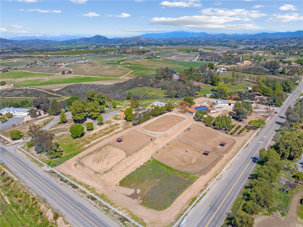 Blanca Rosa — Prime Temecula wine country location just off Calle Contento & Madera de Playa. This 5-acre property boasts turnkey equestrian facilities in the heart of Southern California’s vineyard region, only 15 minutes to the freeway. Horse enthusiasts will appreciate the 8-stall barn with wash racks, feed room, and tack room, plus a 75' × 150' arena, a 50' round pen, and fenced pastures. Ride out through the nearby wine country riding trails for a fantastic lunch at one of the many award-winning wineries. The beautifully updated 3 bed, 3 bath home blends country warmth with modern updates, featuring bright living spaces, a well-appointed kitchen, comfortable bedrooms, and owned solar. Recent improvements include new attic insulation and a roof less than 2 years old. From the property, enjoy sweeping views of vineyards, nearby wineries, and snow-capped mountains. Just minutes from Galway Downs & CRC, this rare find combines location, functionality, and privacy for a true wine country equestrian lifestyle.