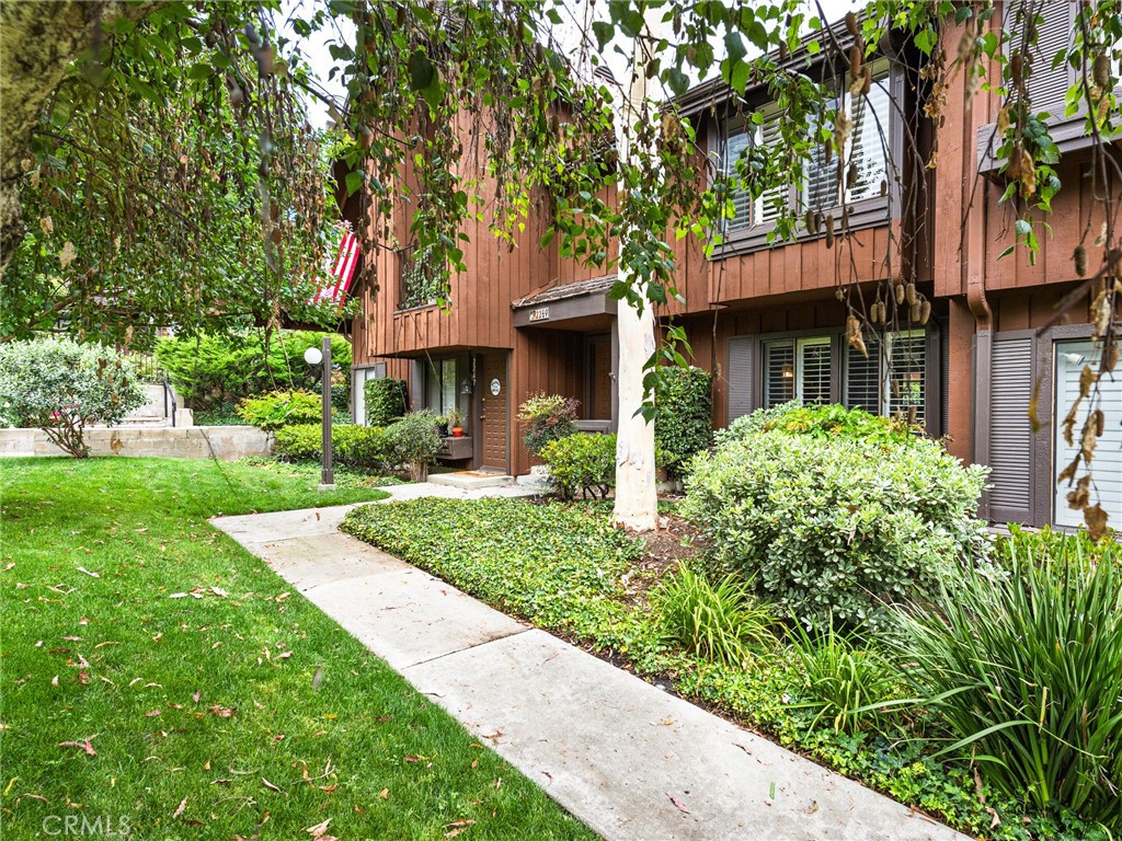 An opportunity like this doesn't come up very often!!!! This immaculate TOWNHOUSE is in a great location in "THE GARDENS". At the north edge of the complex, it's quiet and has plenty of convenient guest parking. It's a sought after TWO PRIMARY SUITE floorplan. New interior paint. Remodeled kitchen with new stainless steel range, microwave and dishwasher along with gorgeous green stone countertops. A large garden window looks out onto the brick patio that is accessed through the double French doors from the dining area. The kitchen, dining area, living room and half bath have stone flooring while
the entry, stairs and bedrooms have oak wood flooring. One primary suite has a walk-in closet with an organizer, a window seat and plantation shutters. The other primary suite has 2 large closets with mirrored doors, closet organizers and more plantation shutters. CHECK IT OUT BEFORE IT'S GONE!!!