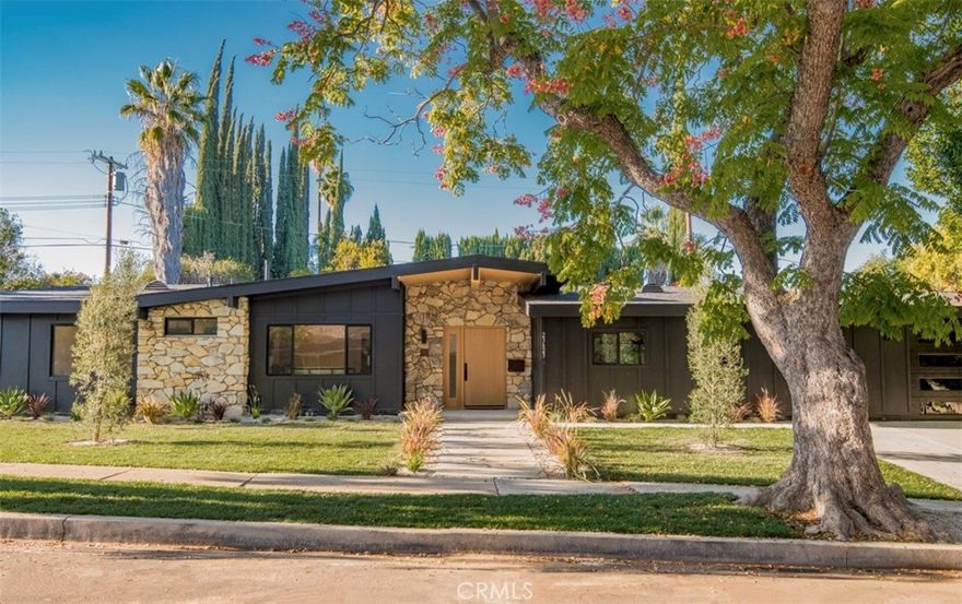 Step into timeless style and modern luxury with this beautifully renovated mid-century home nestled in the heart of one of Woodland Hills most desirable neighborhoods. This stunning 4-bedroom, 3-bathroom residence perfectly blends classic architectural charm with contemporary finishes and thoughtful design. An open-concept floor plan showcases expansive living spaces with real white oak shiplap ceilings, clean lines, and abundant natural light pouring through the home. The chef’s kitchen features sleek custom oak cabinetry, Macchia stone countertops, premium stainless-steel appliances, designer light fixtures and a generous island perfect for entertaining. The primary suite offers a serene retreat with a spa-like ensuite bathroom and access to the private backyard oasis. Twin walk in his & hers closets, a seamless walk in shower, stand-alone tub, Italian porcelain tile, white oak tower cabinetry and Delta fixtures. Each additional bedroom is spacious and bright, while all three bathrooms have been tastefully updated with designer fixtures and finishes. Enjoy seamless indoor-outdoor living with sliding glass doors that open to your private landscaped backyard featuring a newly built BBQ area with refrigerator, grill and seating, a sparkling backyard pool which sits at the heart of the outdoor space, ideal for gatherings or relaxing under the California sun. Every inch of this home has been reimagined—from new oak flooring and lighting to updated plumbing, electrical, roof, sewer, AC, furnace, tankless water heater, windows, doors, kitchen, bedroom, bathrooms and energy-efficient systems—delivering both comfort and peace of mind. Minutes from Ventura Boulevard, Topanga Village, Hiking trails and award-winning schools.