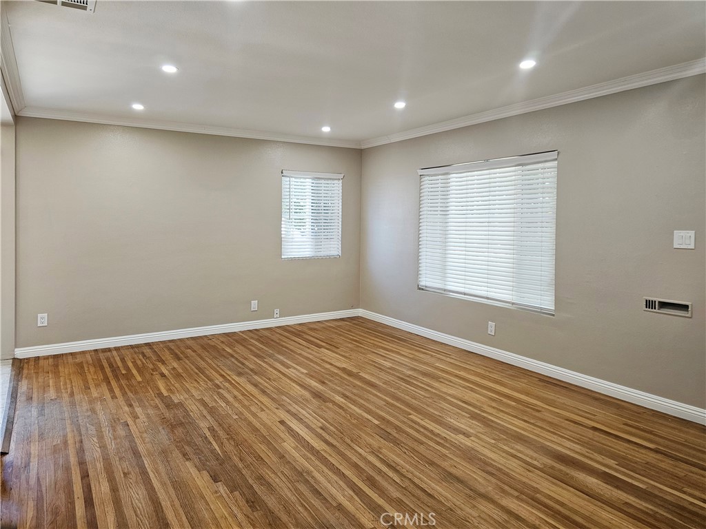 This 3-bedroom, 2-bathroom home offers a comfortable layout with a living room and adjacent dining area, hardwood floors, and recessed lighting. The kitchen is equipped with a brand-new refrigerator, stove and microwave. There is a separate stackable washer & dryer near the bedrooms. The primary suite includes its own private bathroom with dual sinks and two mirrored closets. Two additional bedrooms and bathroom provide flexible space for family, guests, or a home office. Gated parking for two cars adds both security and convenience. Property has a new roof. Future ADU on property is currently unoccupied, will be fenced off and is not part of the lease. Owners are looking for individuals with a credit score of 700 or higher and documented income. Owners may consider 1 small pet. Roscoe has anti-gridlock parking restrictions, please note parking restrictions on certain days/hours.