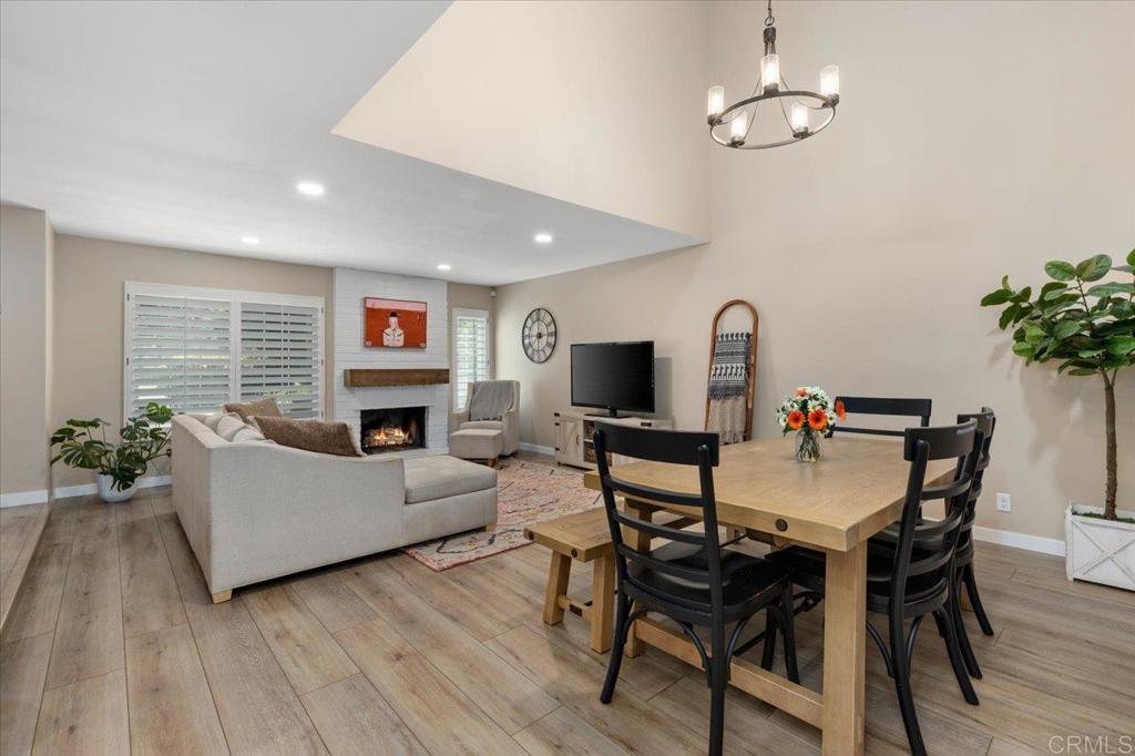Pride of ownership shines in this 3 bedroom, 2.5 bath, 1,492 square foot townhome with a private backyard and attached two-car garage. The home is thoughtfully upgraded with CoreTec luxury vinyl plank flooring, recessed lighting, plantation shutters, and central AC, plus a brand-new roof for peace of mind. The welcoming front patio leads into a light-filled living room with high ceilings and a fireplace, flowing seamlessly to the dining area and kitchen. The remodeled kitchen is warm and pristine, showcasing updated cabinetry, quartz countertops, stainless steel appliances, breakfast bar seating, and a lovely kitchen nook that opens to the large backyard patio and two-car garage. Upstairs, the primary suite offers a private balcony, en suite primary bath with dual sink vanity, and walk-in shower. The second floor is complete with two spacious secondary bedrooms with ample closet space, and a beautifully finished additional bath with shower-bathtub combo. Enjoy amenities within the tight-knit Vida Pacifica community, including a recently resurfaced pool and spa, and a playground. Ideally located 3.7 miles from the beach and downtown Encinitas, and just minutes to Flora Vista Elementary, Diegueno Middle School, Trader Joe’s, Sprouts, Target, parks, and favorite local coffee shops and restaurants. This inviting townhome combines comfort, convenience, and coastal living in the heart of Encinitas.