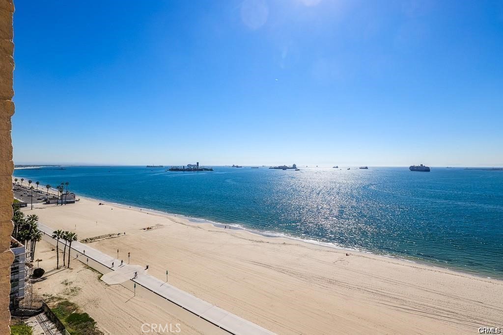 Live the beachfront lifestyle you’ve been dreaming of in this beautifully upgraded, light-filled condo with stunning ocean views. Perfectly positioned right on the sand in one of Long Beach’s most iconic communities—Queen’s Surf—this turnkey home offers the ideal blend of comfort, convenience, and coastal charm. Floor-to-ceiling windows fill the space with natural light and showcase expansive ocean views, while the modern kitchen with stainless steel appliances flows seamlessly into the open living area and private balcony—perfect for enjoying morning coffee or sunset evenings. Additional features include in-unit laundry, central heat and A/C, one dedicated parking space with storage (plus an optional second space for rent), and HOA dues that include Fios cable TV, internet, Wi-Fi, and water. Enjoy resort-style amenities such as a saltwater pool and spa, fitness center, sauna, community room, and direct beach and bike path access. Ideally located near Belmont Shore, The Pike, Pine Avenue, Bixby Park, and the local farmer’s market, this is coastal living at its finest—where every day begins and ends with the sound of the ocean and the beauty of the shoreline.