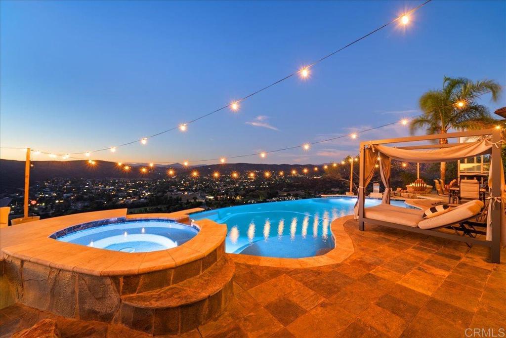 Resort-style living. Stunning, sweeping panoramic views with an INFINITY POOL with cascading water that flows right into the horizon. Entertain in style with an Inground spa/bar and firepit with sunset views. Warning: Once you move in your friends may never leave. 4+ bedrooms PLUS 2 potential ADUs. Light and bright, open floor plan. The living room features a dramatic see-through fireplace and VIEWS. Island kitchen, complete with stainless appliances and more VIEWS. Lurxury primary suite and spa-like bath with fireplace and forever VIEWS. PAID-FOR SOLAR keeps utility costs low. Quiet, prime and sought after location on an exclusive cul de sac. A rare opportunity in San Diego County