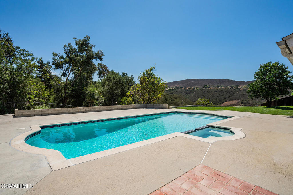 WOW! This stunning home offers breathtaking views of the hills and surrounding nature, nestled in a prime location near the Wildwood hiking trails, Wildflower Playfield (featuring tennis courts, basketball, playground, and more), and the highly sought-after Wildwood Elementary School.Step outside to your private backyard oasis, where a freshly replastered pool and spa await, surrounded by lush new sod, some fresh landscaping, and a variety of citrus trees--perfect for relaxing or entertaining.Inside, the home features a versatile and spacious floorplan, including two Primary Suites--one located upstairs for added privacy and another conveniently situated on the main level. Two additional bedrooms are also on the main floor, ideal for family, guests, or a home office.The light-filled living room boasts a cozy fireplace, while the open-concept kitchen impresses with a large center island, dining area, and expansive windows offering views of the backyard and hills beyond.All three bathrooms have been beautifully updated, adding to the home's modern appeal. Laundry is located in the attached 2-car garage for added convenience.This is more than just a home--it's a lifestyle. Don't miss this one-of-a-kind opportunity!