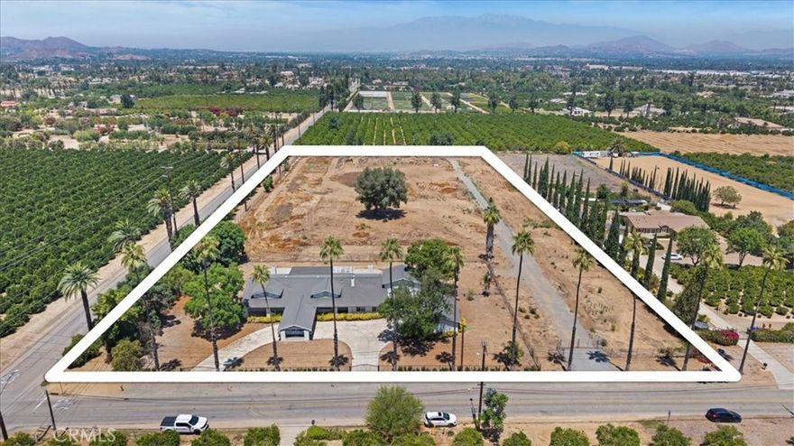Amazing Arlington Heights opportunity! Prime location just east of the California Citrus State Historic Park.  Unobstructed views in all directions.  FLAT 5 acre parcel with Gage Canal water shares (discounted agricultural water)...ideal for citrus, avocado, nursery business, etc. Plenty of space for a barn, shop, sports court, and complete equestrian facilities. Zoned RA-5 (5 acre minimum) makes this part of town one of the MOST desirable for for custom homes and estates.  Flexible floorplan, ideal for multigenerational living, 6 bedrooms ALL on the first level, separate entry along the eastern edge of the home could become an ideal ADU within the existing floorplan and still utilize 5 bedrooms for the main home.  Open kitchen, spacious family room, 3 fireplaces (including one in the primary suite).  This could be transformed into one of the most impressive estates in the area.  Gated circular driveway, detached garage with ample storage, multiple entry gates including the western edge along Irving Street.