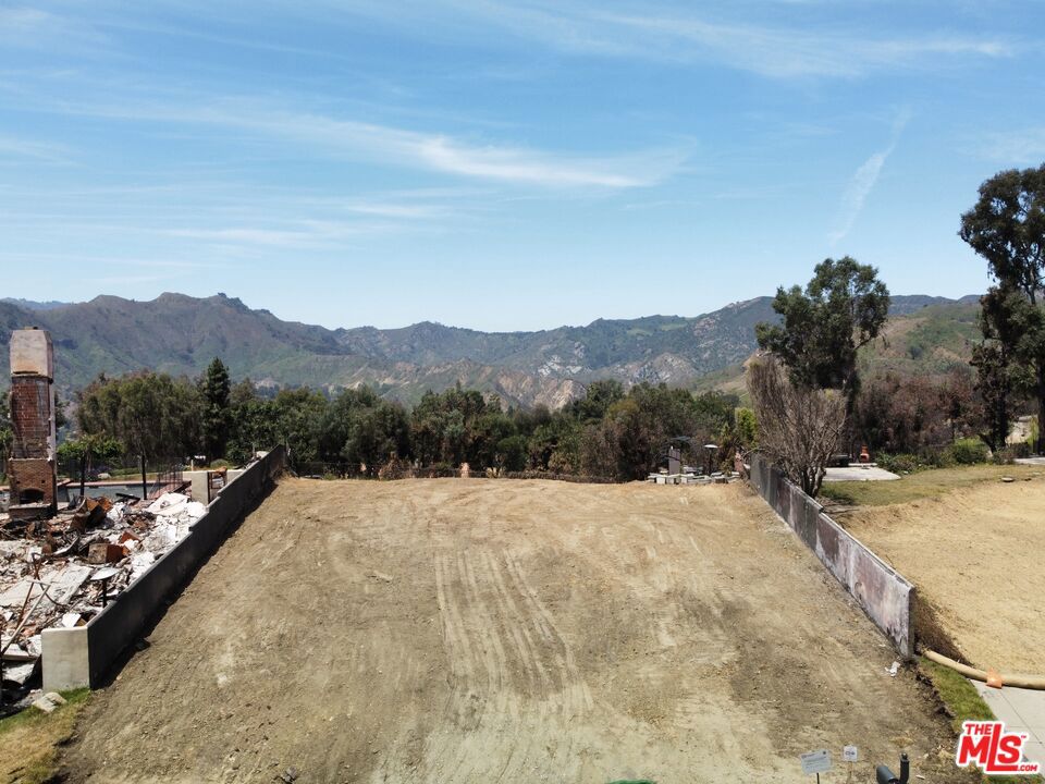 UNPRECEDENTED OPPORTUNITY IN THE HIGHLANDS. This17,864 square foot lot sits on one of the only flat cul-de-sacs in the neighborhood with sweeping mountain and canyon views. This is an opportunity to rebuild a 4,106 square foot home plus an additional 10% square footage for a buildable maximum of 4,517 square feet through the fast track permitting process OR to build a home of maximum square footage per the lot size with traditional permitting process. EPA Phase I is complete and Phase II is being completed by the Seller, including the removal of pool and driveway. There is limitless potential for the visionary buyer to dream big with this oversized lot, which includes membership to the Palisades Hills Rec Center with pool and tennis courts, as well as membership to the Palisades Drive RecreationAssociation which includes dog park, baseball field, running track, outdoor workout equipment, picnic area, and much more. This is a chance to invest in the Pacific Palisades Highlands, one of the most close-knit and sought after communities in all of Los Angeles.