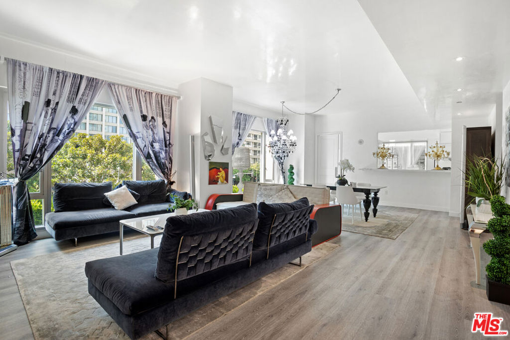 Welcome to The Remington, a premier full-service high-rise on the prestigious Wilshire Corridor, where refined architecture and meticulously curated design converge. This elegant 2BD/4BA residence offers private elevator access, Venetian plaster walls and ceilings, and a tranquil modern palette enriched by plush textures and vintage accents. Floor-to-ceiling windows flood the open-concept living area with natural light, highlighting a contemporary fire feature and a gourmet kitchen with Sub-Zero refrigeration and Miele appliances. The primary suite features a spa-like bath with soaking tub, rainfall shower, wall-mounted body spray jets, luxe finishes, and a built-in television. Both ensuite bedrooms are appointed with built-in televisions and refined design details. Additional highlights include in-unit laundry, central air, custom closets, and seamless Wi-Fi. Residents enjoy world-class amenities: 24-hr concierge, valet, guard-gated entry, private library, wine storage, banquet room, fitness center, and serene pool and garden lounges. HOA includes earthquake insurance, internet, water, and TV. Minutes to UCLA, Beverly Hills, and Westwood Village.