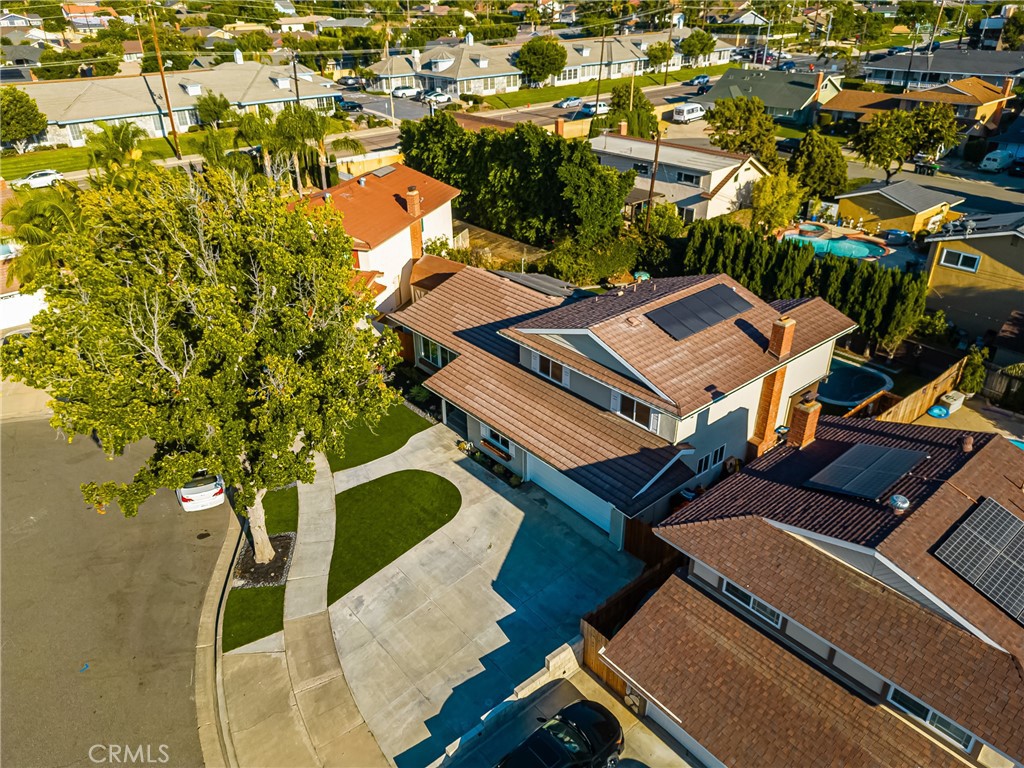 Step into this beautifully remodeled 4-bedroom, 3-bathroom pool home, perfectly situated on a quiet cul-de-sac in one of Orange’s most desirable neighborhoods. The home greets you with stunning curb appeal, a wide driveway with curved walkways, manicured landscaping, and a welcoming covered entry. Inside, the bright open floor plan features expansive dual-pane windows, recessed lighting, and warm-toned wide-plank flooring throughout. The chef’s kitchen is a true showpiece with custom white shaker cabinetry, quartz countertops, stainless steel appliances, a built-in microwave, and an oversized island with pendant lighting and seating for five. A dedicated wet bar area with wine fridge and prep sink opens to the dining space, creating the perfect flow for entertaining. Upstairs, you’ll find generously sized bedrooms with modern finishes and ample closet space, while the sleek bathrooms feature floor-to-ceiling tile, contemporary fixtures, and a frameless glass shower with mosaic inlay. The downstairs bedroom and full bath offer flexibility for guests or multi-generational living. Step outside to your private backyard oasis, complete with a sparkling pool, custom play structure, lush artificial turf, and an expansive patio perfect for lounging or dining al fresco. Located just minutes from highly rated Villa Park schools, shopping, dining, and commuter routes—this turnkey home is the perfect blend of style, comfort, and convenience.