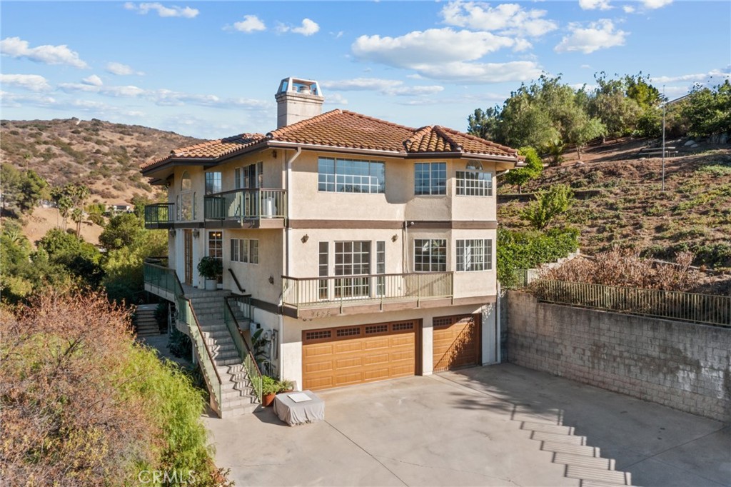 Welcome to your own hilltop hideaway in Shadow Hills! Tucked away at the end of a long, gated driveway, this beautiful three-level home offers a rare combination of total privacy, abundant natural light, and incredible 360° views. Whether you’re sipping coffee as the morning sun rises over the mountains or watching the city lights twinkle at night, the scenery here never stops impressing.
With 3,144 sq ft of thoughtfully designed living space, you’ll find 4 spacious bedrooms, 4 bathrooms, and plenty of room to spread out and make yourself at home. The most recently renovated first-floor room and bathroom offer a versatile space—perfect for a game room, large office, or guest area—with a walk-in shower featuring double shower heads. The bright, open layout is filled with large windows that flood every room with sunshine and frame sweeping views from nearly every angle. Multiple fireplaces add a cozy, welcoming touch, perfect for gathering with family and friends on cool evenings.
The kitchen offers generous space for cooking and entertaining, ready for everything from easy weekday breakfasts to festive holiday dinners. Hardwood, tile, and carpet flooring flow throughout the home, creating a comfortable blend of elegance and warmth. Each level offers its own unique perspective on the surrounding landscape, making every space feel special.
Outside, your 1.05-acre lot is a blank canvas for whatever you dream up—whether it’s a sparkling pool, a lush garden, or a stylish guest house for visiting family and friends. There’s space to entertain, relax, and soak in the serenity all year round.
Here, you’ll enjoy the best of both worlds: peaceful, private living with easy access to the amenities, shops, and dining of the surrounding communities. This is more than just a house—it’s a lifestyle, and it’s a rare opportunity to own one of Shadow Hills’ most scenic properties.