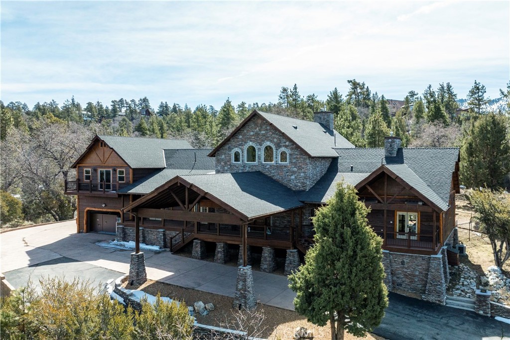 A luxurious 5-bedroom, 6-bath custom mountain estate located in the gated Fox Farm area. Built in 2007, the home spans nearly 5,000 sq ft on a private 1.87-acre lot. Grand entry with soaring wood-beamed cathedral ceilings and slate floor. Open floorplan with multiple living areas, including a family room, formal living, loft/game room with wet bar. Gourmet kitchen: warm wood cabinetry, stainless appliances, granite countertops, breakfast bar, and walk-in pantry. Wine room: temperature-controlled, adjacent to kitchen. Fireplaces (3 total): located in living room, family room, and the master suite, all adorned with stacked-stone finishes. Composite decks at both front and back, accessible from all bedrooms, offering serene forest and mountain views. Large covered front porch and a matching rear deck for entertaining. Four-car attached garage + porte cochère & driveway with gated private drive. Bonus office/nursery off the primary suite, complete with custom dog-run. Temperature-controlled wine room & walk-in pantry for storage convenience. HVAC with central air, whole house humidifier, forced-air heating. Luxury finishes: beamed ceilings, slate/tile/wood flooring, double-pane windows, wet bar. Security system owned. Captivating views of surrounding mountains and forest from multiple vantage points
Located in Big Bear’s central Fox Farm area, just minutes from ski slopes, the lake, hiking, and local amenities. Gated entry with private road leading up to property. Offered fully furnished.
ZONED SAN BERNARDINO COUNTY - ALMOST 2 ACRES - CAN BUILD ADU - CONTACT COUNTY FOR DETAILS.