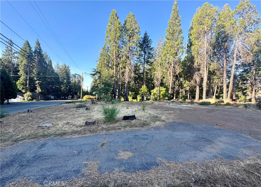 Easy to build level lot in the heart of Magalia! This large corner lot with a driveway on Creston AND a driveway on Wingate Cir is cleared and ready for construction to begin. Huge savings on this lot as power and FUNCTIONING septic system are already in place. New leach lines were installed in Nov. 2019 by Dobrich and Sons. This lot is located in the POA which offers many amenities including a pool, playground, tennis courts, hiking trails, and so much more!