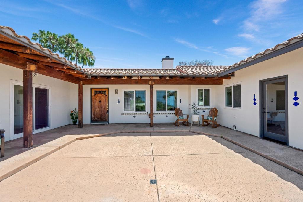 Welcome to 869 Eugenie Avenue, a distinctive home in Encinitas designed and built by a local artist. This captivating 3-bedroom, 2-bathroom residence, with an additional 400 sq. ft. 1-bedroom, 1-bathroom attached ADU, blends South-West architectural flair with breathtaking ocean views. With a total of approx. 2,005 sq. ft. of living space on a sprawling 14,393 sq. ft. lot, this property offers ample room for creativity and relaxation. The home seamlessly connects indoor and outdoor living through expansive sliding glass doors leading to five generous patios. This unique flow invites the ocean breezes in and extends your living space to the vibrant outdoors. The property boasts two versatile outbuildings, ideal for an office and an art studio. Inside, enjoy the charm of Mexican Saltillo pavers in the living areas and warm wood floors in the bedrooms. The kitchen was recently remodeled with fresh new look and feel, complemented with hand-painted tiles in each bathroom, adding a touch of artistry throughout. The spacious 28' x 18' living and dining area features soaring 11’ cathedral ceilings and a dramatic fireplace, perfect for gatherings. Additional amenities include an attached 2-car garage with a workbench, ample driveway and RV parking with hookups, and a washer/dryer in the unit. Experience the beauty and creativity of this home. A must-see gem just moments from local attractions and the ocean.