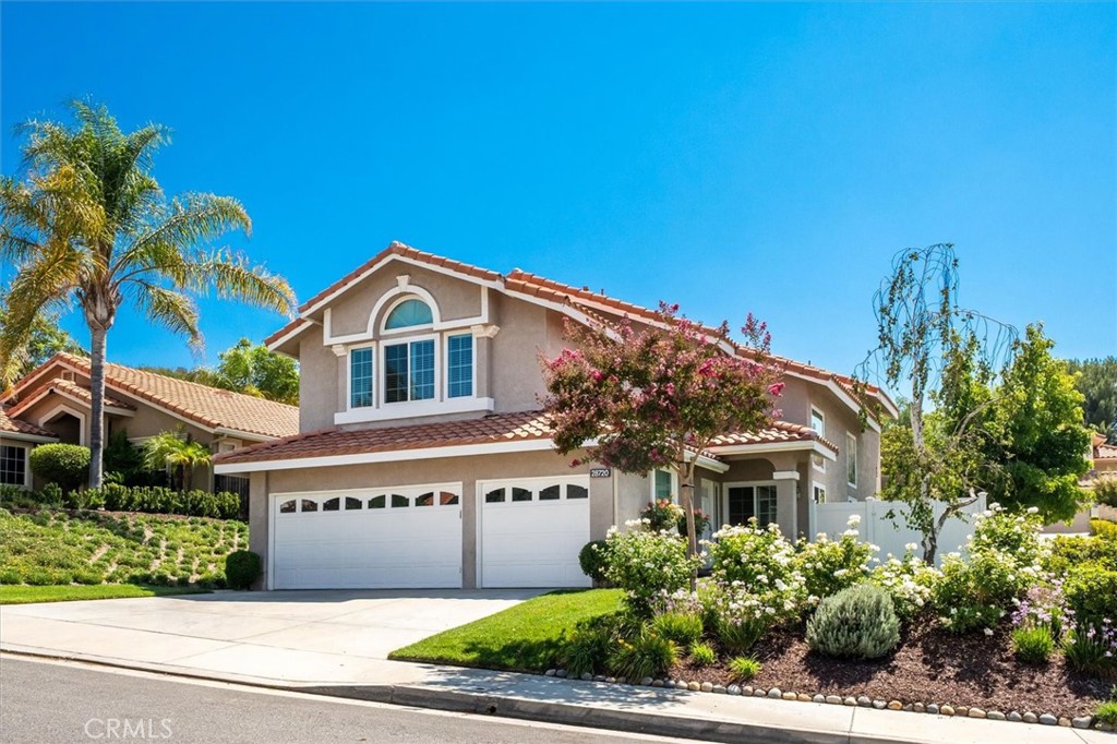 Upgraded and updated from top to bottom, including a replaced tile roof and nearly every inch of the interior, this 4-bedroom plus bonus room home offers stunning style, quality finishes, and the benefit of no HOA and no mello roos. Inside, you’ll find beautiful porcelain tile wood-grain floors downstairs, LVP upstairs, designer interior paint, plantation shutters, and all Moen fixtures throughout. The remodeled kitchen features Ceasarstone countertops, white shaker cabinets with pull-outs and turntables, a large Ruvati sink, GE stainless steel appliances, and a tile backsplash with marble accents, all opening to the family room with gorgeous built-ins for storage and serving space, plus a fireplace with a custom marble mosaic surround. All bathrooms have been remodeled with granite, marble, or porcelain finishes, including the luxurious primary bath with a seamless walk-in shower, soaking tub, dual sinks, and custom moulding. The primary suite also offers two walk-in closets. Additional upgrades include all 22 dual pane California Deluxe windows and a brand new water heater. The backyard is open and lush with a patio that enjoys afternoon shade, vinyl fencing, and extra space thanks to a flaglot driveway on one side. Practical features include a whole house vacuum system, indoor laundry room, and a 3-car garage. A downstairs bedroom with full bath, including a walk-in shower, completes this exceptional move-in-ready home.