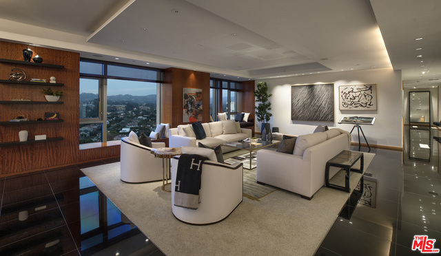 Perched high above the City of Angels is a contemporary vision of urban indulgence. Expertly choreographed from the 15th floor of the Californian on the Golden Mile, known in LA as the "Wilshire Corridor", rests an expansive condominium that stretches from East to West. At almost 5,300 square feet, this rare double unit features 3 bedrooms, 3.5 bathrooms, exotic woods, such as shedua and wenge from Africa, stunning polished black granite floors, glorious walls for art and a cosmopolitan sensibility. Amenities include: 5 hole putting green, doggy park, luxurious formal living and dining room, oversized marble master bathroom with separate his/her walk-in closets, state-of-the-art media room with cashmere covered walls, chef's kitchen and eat-in bistro with transparent/frosted electric glass and dazzling illumination that reveals a dance between the urbane aesthetic and an unobstructed view of the Pacific. This chic condominium is the ultimate in high-rise luxury living.