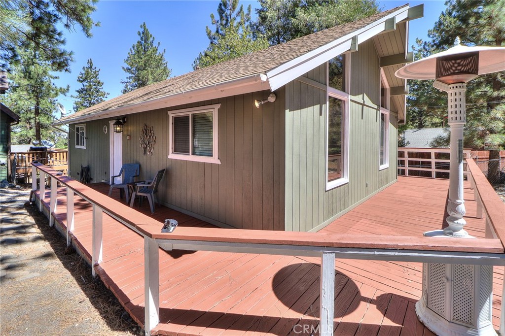 Peaceful 2 Bed + Loft, 1 Bath Mountain home on large lot with mountain views! This well-maintained, beautiful home shows true pride of ownership and is ready for you to make it your own! Set back from the street on an over 7,500 square foot lot, this home provides a tranquil getaway with plenty of room to add on, build an ADU, or trailer/ RV parking. Souring old growth trees provide privacy, and the freshly re-stained oversized wrap-around deck is perfect for enjoying the outdoors morning, noon and night. Entering through the front door and a few steps down the hall, the family room stuns with soaring vaulted, beamed ceiling and nearly floor to ceiling south facing windows featuring a wonderful tree-lined mountain view. Warm yourself by the crackling wood burning fireplace after a day on the slopes at nearby Mountain High resort. The thoughtfully designed kitchen has open sight lines to the family room with stone countertops, two-tone cabinetry with hardware, dishwasher, stove and oven. Down the hall are two good sized bedrooms and a full bathroom with shower and tub, clean and well maintained. Up the ladder is a bonus loft, with open peek-a-boo terrace view of the family room and built in storage. The hall contains a laundry closet with additional storage. Conveniently located near Wrightwood Village and Mountain High, this amazing mountain retreat is ready for you! Do not delay, schedule a showing today!
