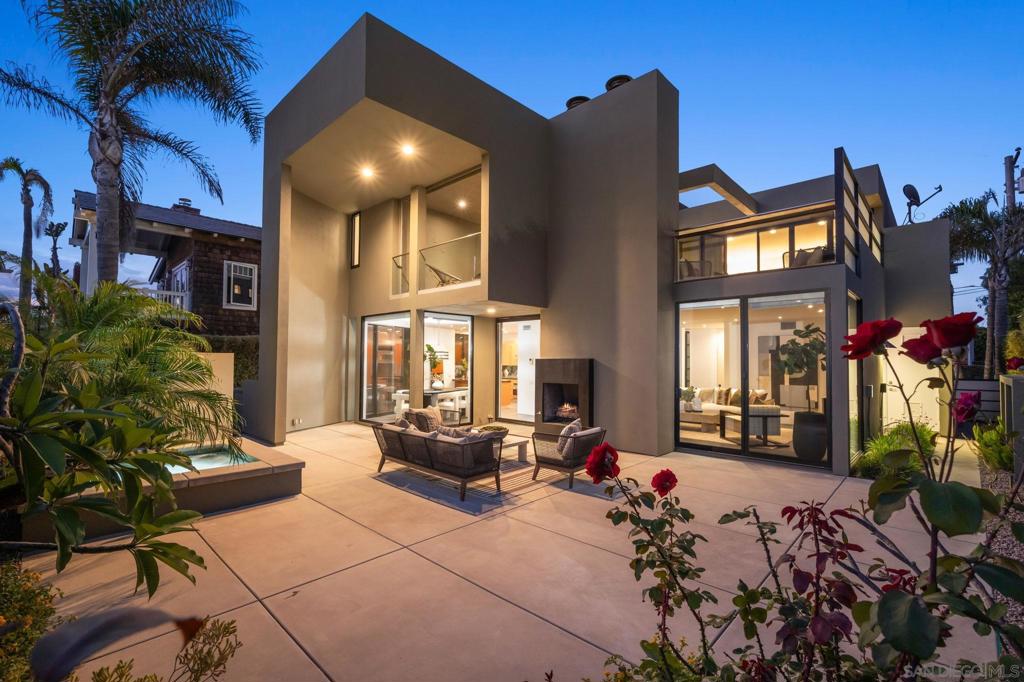Modern Coastal Retreat in Prime Del Mar Beach Colony at 2402 Camino Del Mar ~ Steps to the sand, this stunning contemporary home is a rare find in the highly desirable Del Mar Beach Colony. Featuring 4 bedrooms, 4.5 bathrooms, and seamless indoor/outdoor living across two levels, the main floor features a dramatic entry, expansive great room with floor-to-ceiling glass and a custom pivot door that opens to a private backyard. Enjoy dual fireplaces, a fully equipped gourmet kitchen with SubZero and Chef-Grade Appliances, natural light filled dining area, and built-in outdoor BBQ perfect for entertaining. A separate guest or nanny suite with private entrance, oversized 2-car garage (with beach cruisers included), laundry room, and powder bath complete the main level. Upstairs, the primary suite and two additional en-suite bedrooms open to a massive second-floor deck ideal for lounging, exercise, or taking in the ocean breeze. A private rooftop deck offers 360-degree views—perfect for sunset watching or sunbathing. Tucked behind gates and lush landscaping, this private beach home offers both peace and proximity—steps from the sand, walkable to the Village, and close to top restaurants, shops, and Del Mar Racetrack.