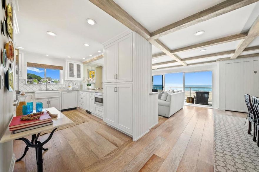 This is a rare opportunity to own a true oceanfront condo directly on the sand at Corcoran Lagoon Beach. From Capitola to the far Westside, there are no other complexes like this. Completely reimagined from the studs up, this 2nd-floor, single-level corner unit showcases high-end finishes, designer touches, and thoughtful details throughout. The open-concept layout features a spacious kitchen with custom cabinetry, a dining and beverage bar with wine fridge, and a luxury French La Cornue range. The kitchen flows seamlessly into a cozy living room with a fireplace and out to a private balcony where you can savor unobstructed views of the beach, bay, and breathtaking sunsets. A spacious dining area and built in bench compliment the space. Both bedrooms are generously sized with ample closet space and ensuite baths featuring custom tile, high-end fixtures, and even TVs including one built into the mirror. A built-in Murphy bed provides extra sleeping accommodations for guests. Additional amenities include in unit washer/dryer, secure gated entry, elevator access, outdoor shower, dedicated parking, private storage and direct beach access. Whether you're seeking a primary residence, a second home, or a potential vacation rental, this property offers the ultimate coastal lifestyle.