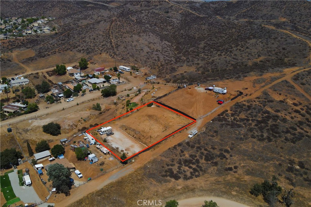 Rare Opportunity! 3 Contiguous Vacant Parcels in Prime Menifee Location! Discover the perfect blend of rural charm and city convenience with this fully fenced .61-acre property, made up of three contiguous parcels sold together. Nestled in the heart of Menifee, this unique piece of land offers peaceful, country-like surroundings while being just minutes from shopping, schools, and freeway access.
A gated entrance provides added privacy and security, and a 2,500 gallon nylon water holding tank is already on-site for your convenience. While there are currently no utilities on the property, this blank canvas is ideal for investors, builders, or anyone looking to create their own private retreat. There is electricity at the pole next door.
Located in the direct path of progress, this is a strategic investment opportunity in one of Southern California’s fastest-growing communities. Don’t miss your chance to own land in this up-and-coming area with endless potential!