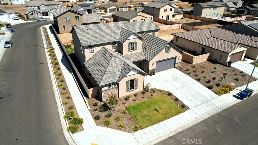 Welcome Home! This radiant 5-bedroom, 3.5-bath stunner rests on one of the largest corner lots in the neighborhood and features a spacious 3-car garage, perfect for your vehicles, gear, or workshop dreams. Located in a picturesque neighborhood served by Clovis Unified School District, it blends top-tier education with curb appeal and undeniable community pride. From the wide, welcoming streets to the peaceful community vibe, this one feels like home from the moment you arrive.

Soaring ceilings and sun-kissed interiors greet you at the door. The spacious Primary Suite includes an oversized walk-in closet and a large en-suite bath with dual vanities for peak functionality and comfort. A versatile flex room awaits your dream office, home gym, creative retreat or even a potential 5th bedroom.

The chef-inspired kitchen delivers on every level, stone counters, stainless steel gas appliances, and more cabinetry than you'll know what to do with. Entertain in your formal living room, host cozy nights in the family room, or simply enjoy the smart layout with a conveniently located powder room.

Upstairs features a massive loft, ideal for movie nights, hobbies, or play. A large Secondary Suite with own private full bath, and two additional bedrooms serviced by a third full bath, round out the perfect floor plan.

Outside, the yard is a blank slate, ready for a garden, pool, or your backyard masterpiece.

This is more than must-see. It's a must-experience.
